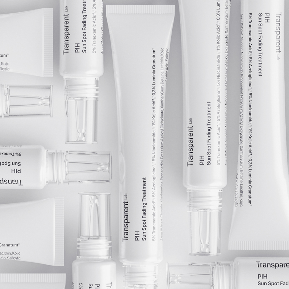Weiße Tuben mit „P.I.H. Sun Spot Fading Treatment“ ordentlich auf einer flachen Oberfläche angeordnet.