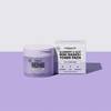 Ein hellviolettes Töpfchen und eine dazu passende Schachtel mit breakout+aid Mini-Masken in den Sorten Blueberry & Açaí sowie Toner-Pads.