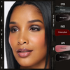 Eine Frau trägt Danessa Myricks Beauty Colorfix Glaze: metallisch graue Augen, rotes Rouge und glänzende rosafarbene Lippen, mit den angegebenen Farbnamen.