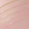 Nahaufnahme von „Over The Garden Wall – Woodsman’s Lantern Shimmering Body Oil“ von Lethal Cosmetics, die die geschmeidige, glänzende rosa Textur des Produkts zeigt.