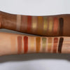 Zwei Arme mit unterschiedlichen Hauttönen zeigen erdige Farbmuster schimmernder und matter Farbtöne aus der LH Cosmetics Creator Palette.