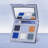 Geöffnete NABLA Cutie Palette, Midnight,  mit sechs Lidschattentönen und einem Spiegel, präsentiert auf einer hellblauen Oberfläche.