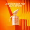 Eine Lumene Nordic-C Dark Spot Serum Flasche mit Tropfer auf einem leuchtend orangefarbenen Hintergrund.