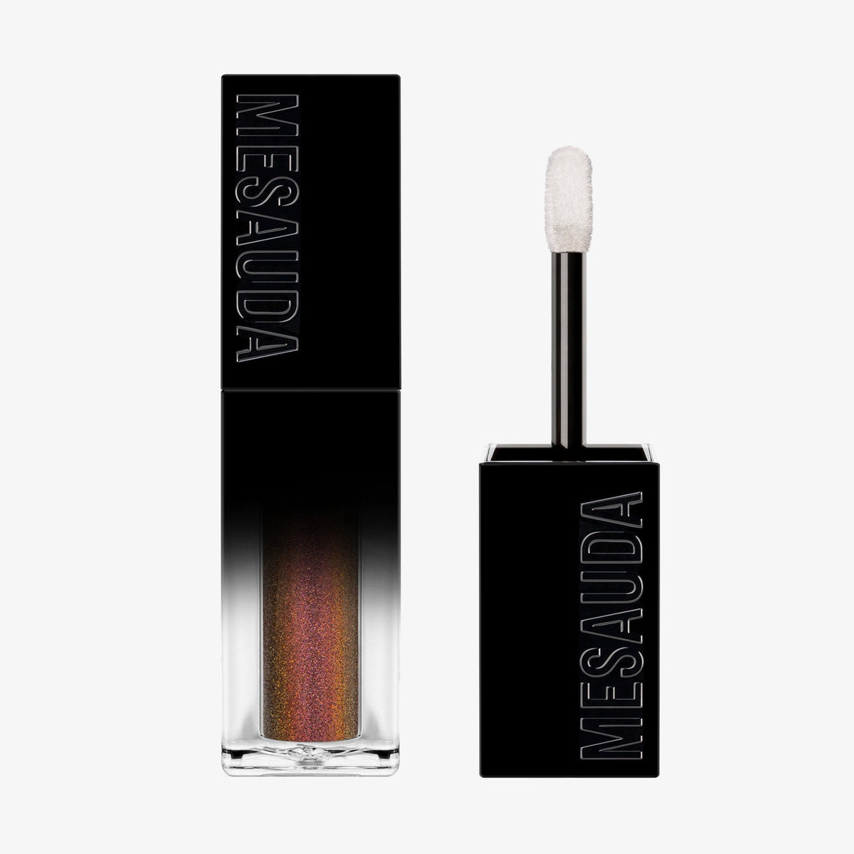 Der Galactic Shadow Flüssigliedschatten von Mesauda Beauty in einer rechteckigen Tube mit dem Deckel und Applikator daneben.
