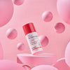 Eine Flasche Vitamin A Glow Retinol Serum, präsentiert auf einer rosa Plattform mit schwebenden rosa Kugeln.