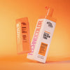 Bondi Sands Technocolor Self Tanning Face Serum und Self Tanning Foam vor einem orangefarbenen Hintergrund mit Farbverlauf.
