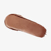 Ein Abstrich des cremigen Blush & Bronzer von Mesauda Beauty auf einem weißen Hintergrund verschmiert.
