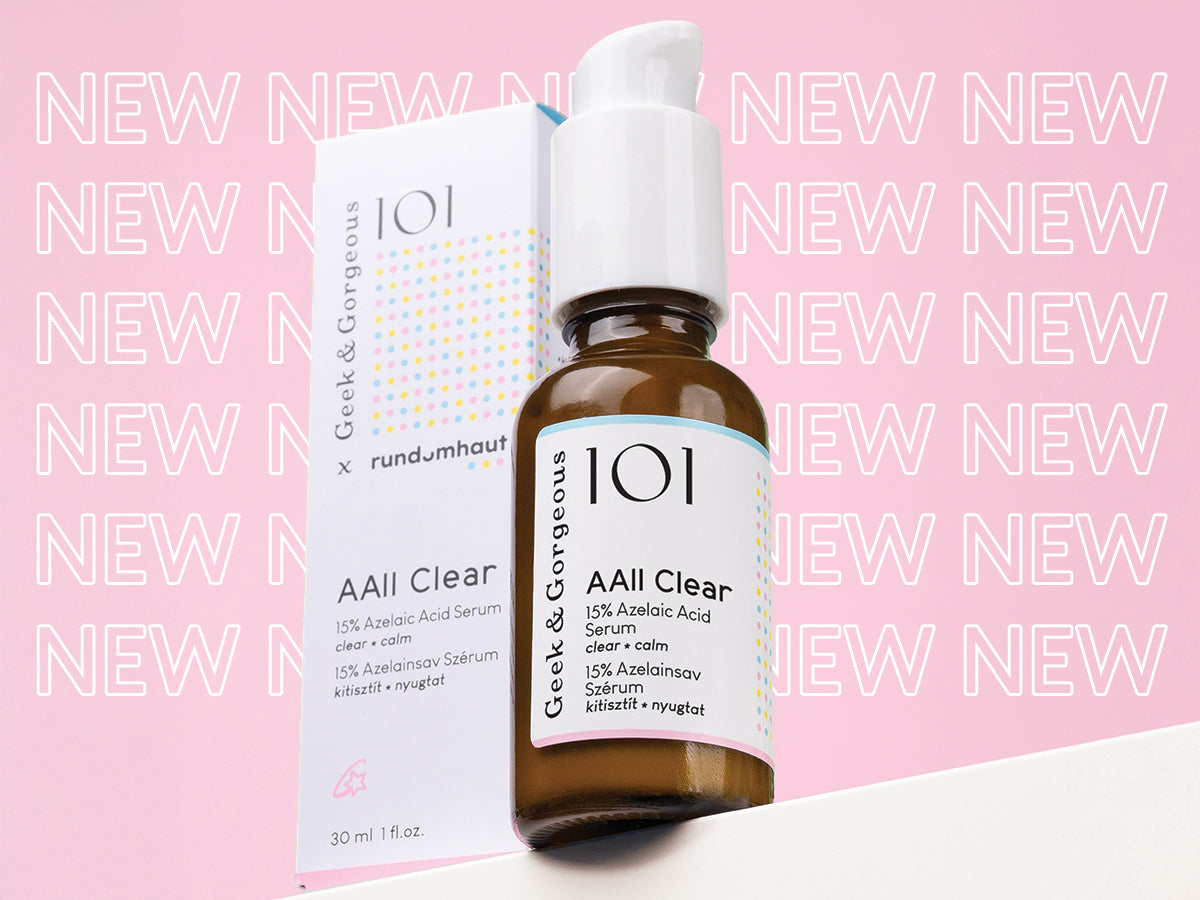 Eine braune Tropfflasche und eine Verpackung des „Geek & Gorgeous AAll Clear“-Serums mit der Aufschrift „NEW“ in rosa Schrift auf dem Hintergrund.