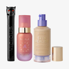 Drei NABLA-Produkte: schwarze Mascara mit Katzenkopf, rosa Angel Aura Serum-Primer und Skin Realist Tinted Balm in der Farbe 2 Light mit lilafarbenem Pumpspender.