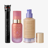 Drei NABLA-Produkte: schwarze Mascara mit Katzenkopf, rosa Angel Aura Serum-Primer und Skin Realist Tinted Balm in der Farbe 2.5 Medium mit lilafarbenem Pumpspender.