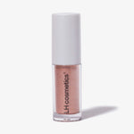 Transparente Tube Sparkl von LH Cosmetics mit weißer Kappe und pfirsich schimmerndem Farbton namens Flirt.