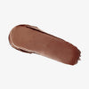 Ein Abstrich des cremigen Blush & Bronzer von Mesauda Beauty auf einem weißen Hintergrund verschmiert.
