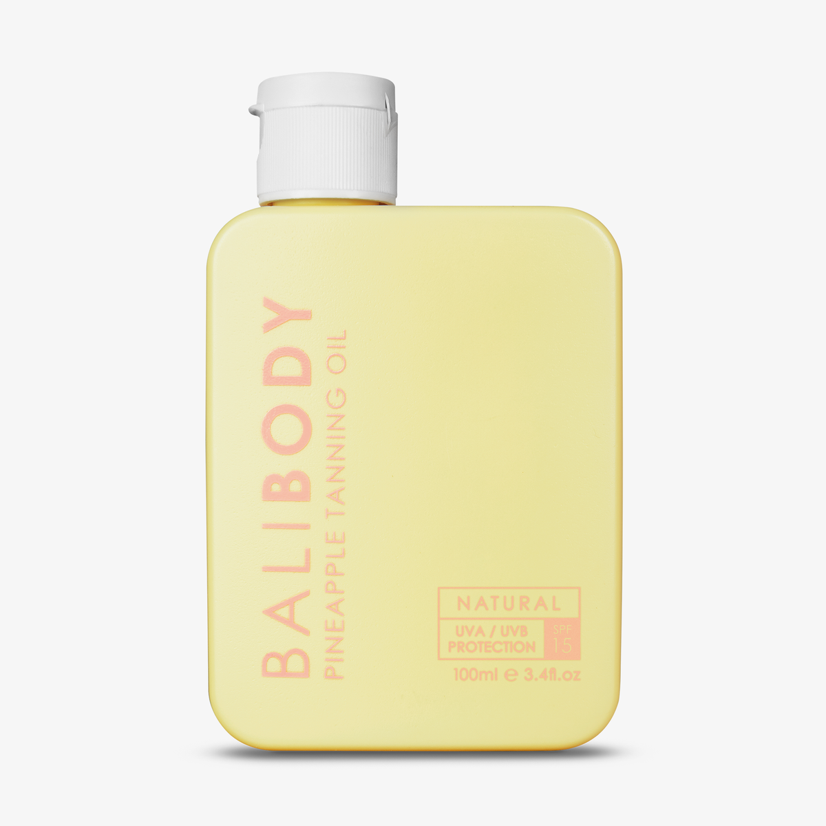 Gelbe eckige Flasche Tanning Oil SPF 15 Pineapple von Bali Body mit weißem Deckel vor weißem Hintergrund