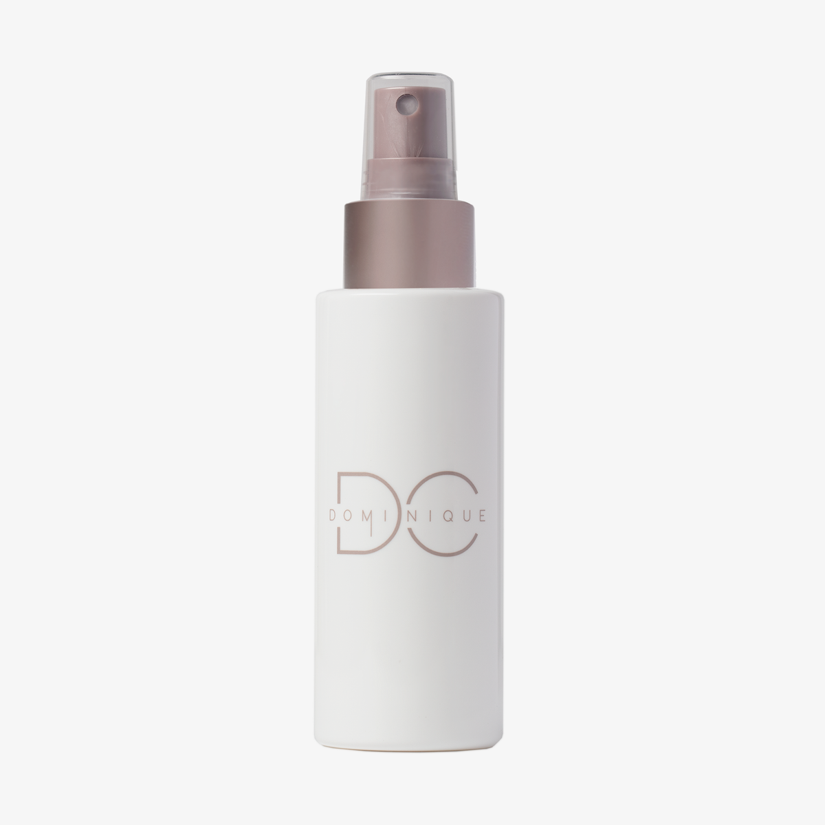 Ultra Hydrating Fine Mist in einer weißen Sprühflasche mit roségoldener Kappe und Dominique-Branding, abgebildet vor weißem Hintergrund.