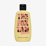 Gelbe Flasche Rapid Face Tanner von The Fox Tan mit einem Palmblattdesign auf dem Etikett.