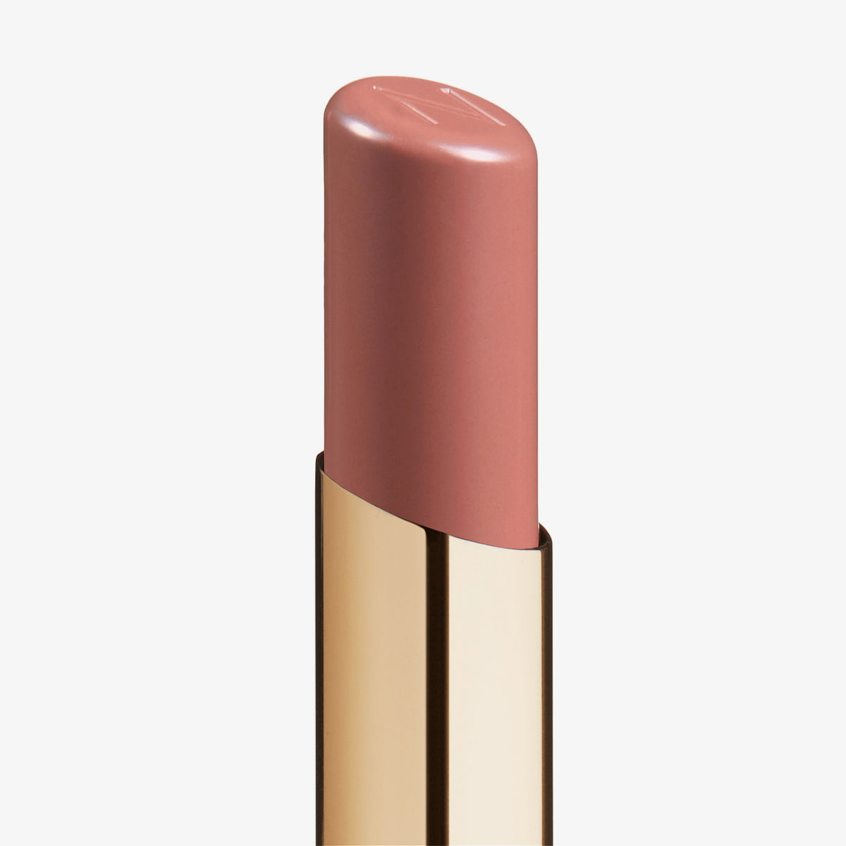 Eine Nahaufnahme des Beyond Jelly Lipstick in der Farbe Lunar in einer glänzenden goldenen Hülse vor weißem Hintergrund.