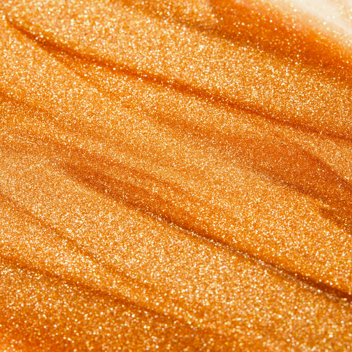 Gold-schimmernde Textur in Nahaufnahme, flüssig und mit feinen Glitzerpartikeln durchzogen.