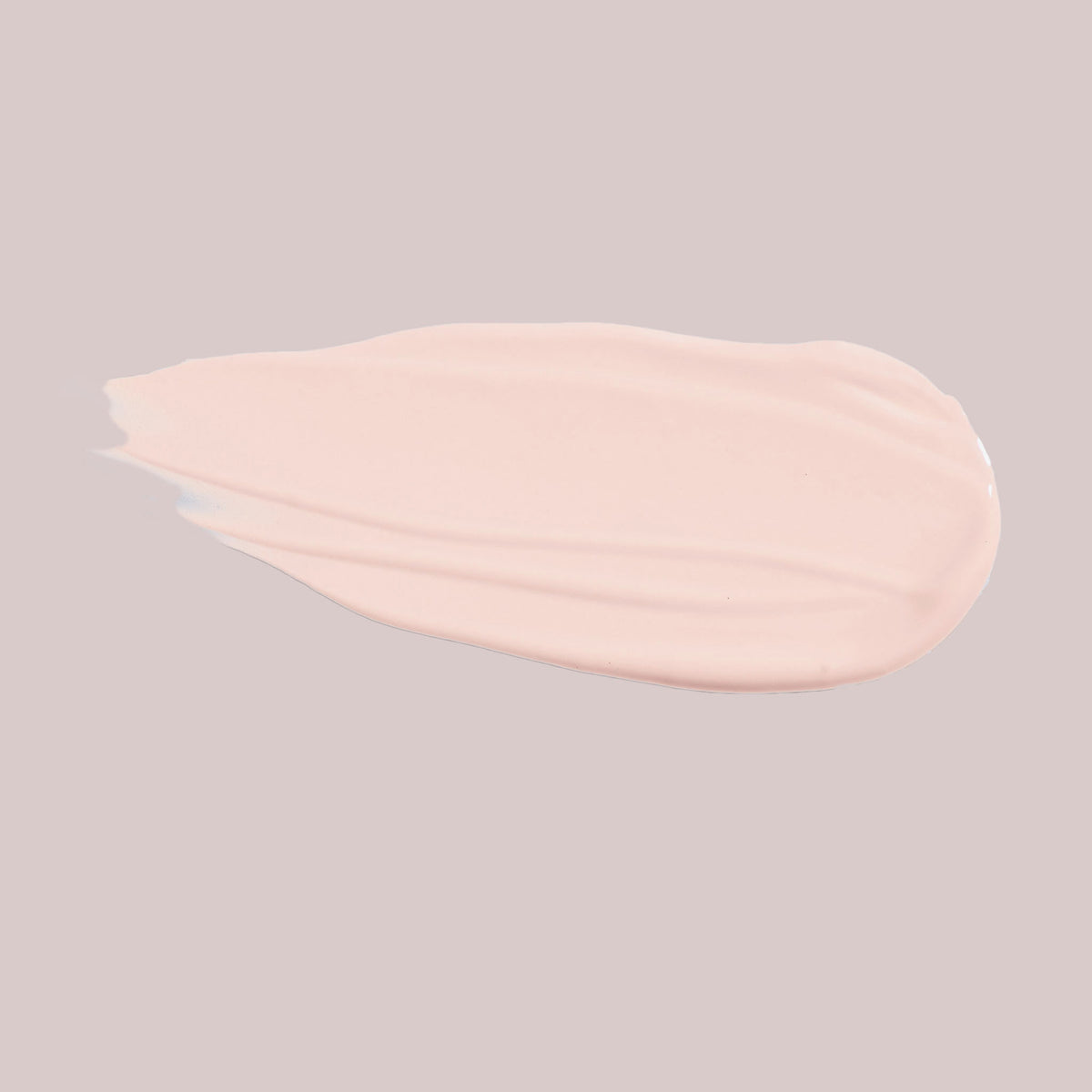 Ein glatter, hellbeiger Fleck Wide Awake Full Coverage Concealer auf einem schlichten, blassen Hintergrund.