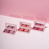 Drei offene Duo Dimension Make-up-Paletten von LH Cosmetics, jede mit zwei Farbtönen und einem Spiegel, präsentiert auf einem rosa-weißen Hintergrund.