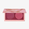 Geöffnete LH Cosmetics Duo Dimension Element Palette mit einem bordeauxrosanem und einem himbeerroten schimmernden Farbton auf weißem Hintergrund.