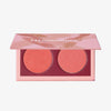 Geöffnete LH Cosmetics Duo Dimension Zone Palette mit einem pfirsichfarbenen und einem korallorangen schimmernden Farbton auf weißem Hintergrund.