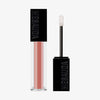 Der Gloss Matrix Lipgloss von Mesauda Beauty in einer rechteckigen Tube mit dem Deckel und Applikator daneben.
