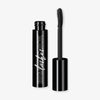 Eine offene schwarze Mesauda Beauty Big and Thick Lashes Mascara-Tube mit einem Applikator steht vor einem weißen Hintergrund.