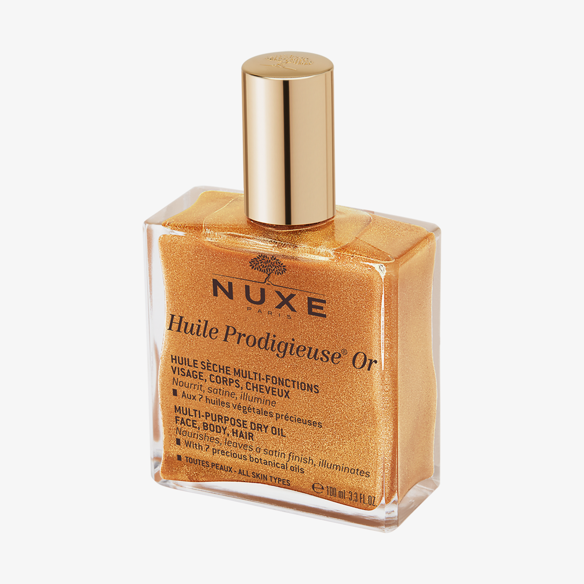 Eine quadratische Glasflasche mit schimmerndem NUXE Huile Prodigieuse® OR und goldenem Verschluss.