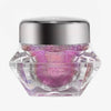 Transparenter Tiegel Infinite Chrome Flakes Cupid mit pink schillerndem Inhalt und silbernem Deckel vor weißem Hintergrund.