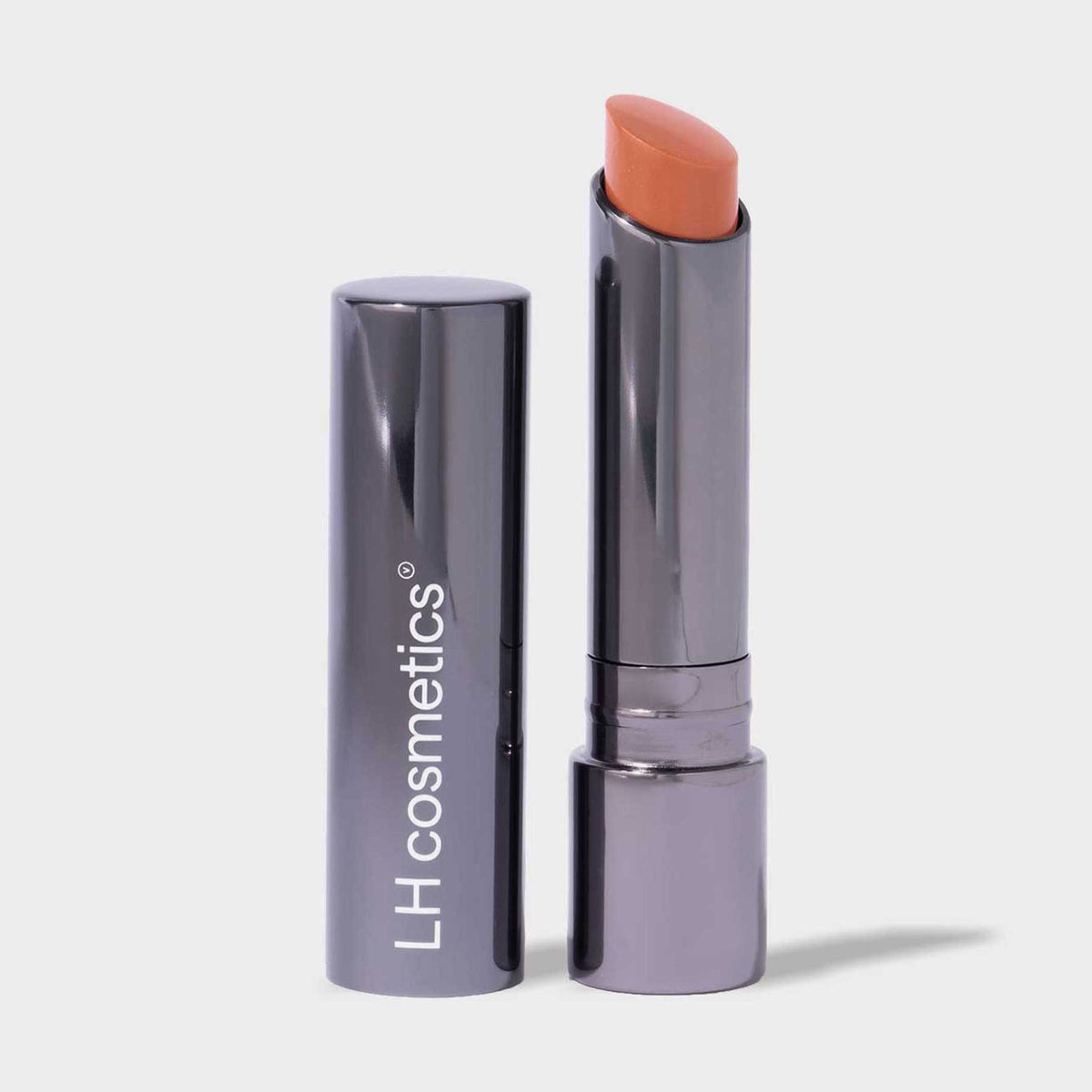 Dunkler silberner Drehstift des Fantastick Lipstick Sunstone von LH Cosmetics mit pfirsich-nudefarbenem Lippenstift auf weißem Hintergrund.